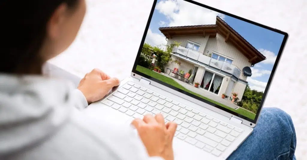 Laptop screen with picture of large house